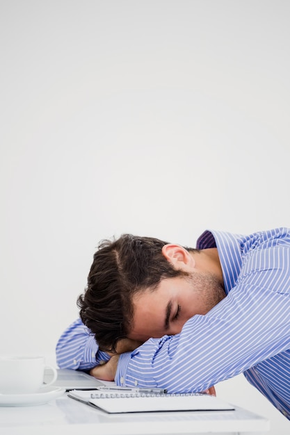 Businessman putting his head down on desk