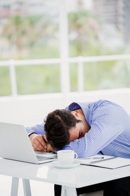 Businessman putting his head down on desk