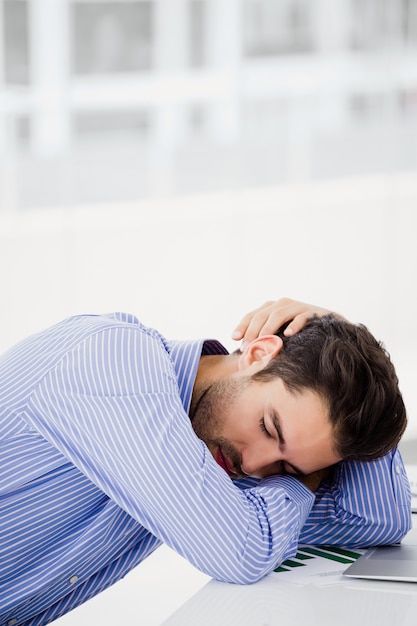 Businessman putting his head down on desk