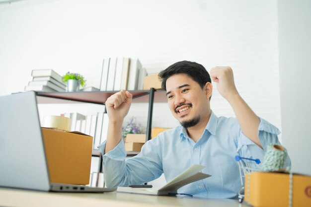 businessman raising hand after complete order or deal big project with partner in home office