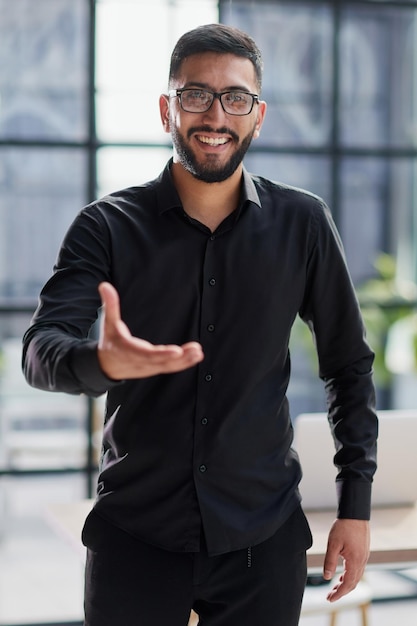 Businessman ready to shake hand in office