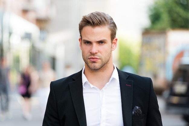 Businessman ready to solve pronlems. Man well groomed elegant formal suit walks urban background. Businessman serious quick walk during lunch time. Businessman handsome attractive office worker.