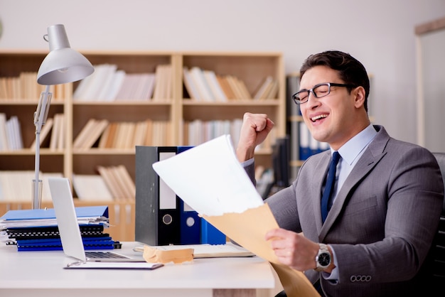 Businessman receiving letter envelope in office