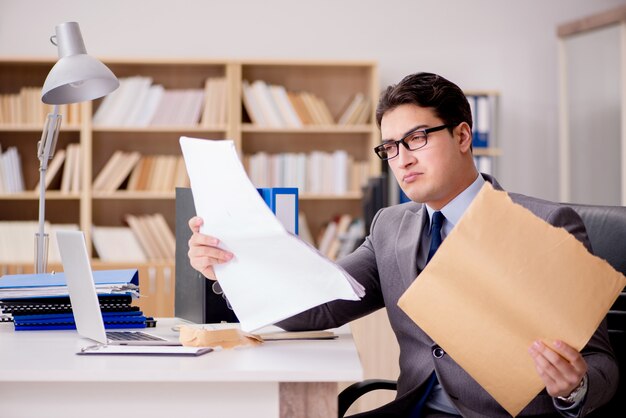 Businessman receiving letter envelope in office