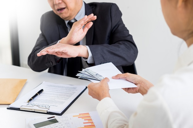 Businessman refusing or rejecting money in the envelope 