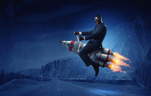 Businessman on a rocket. Mixed media