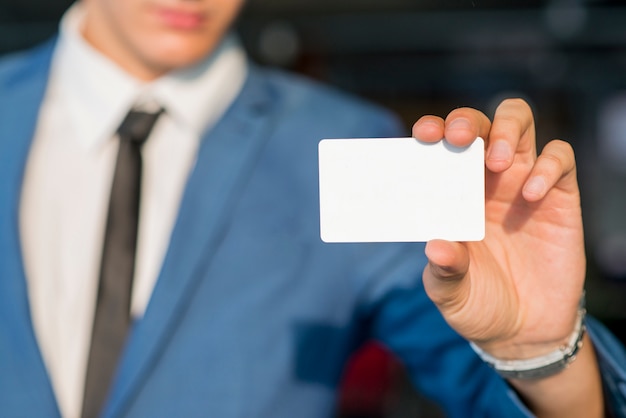 Businessman's hand showing blank white card