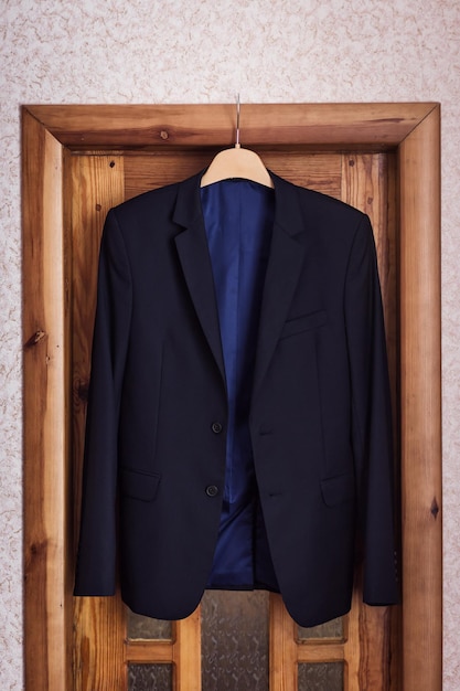 Businessman's jacket is hanging in the room