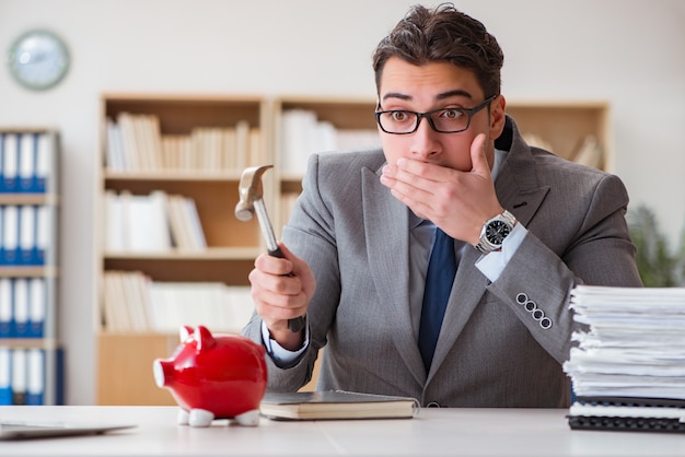 Businessman in search of his savings with piggy bank