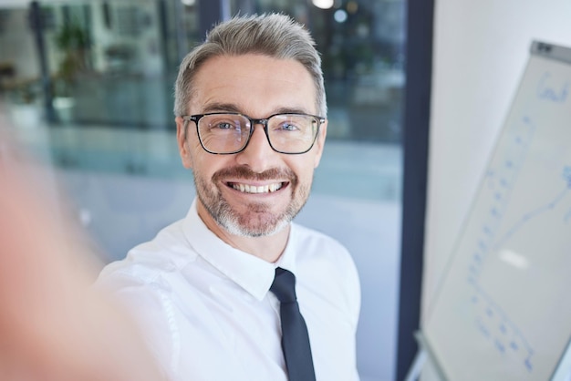 Businessman selfie and happy smile at marketing and advertising company glasses and social media picture Mature man corporate worker or employee with photo happiness and smiling in workplace