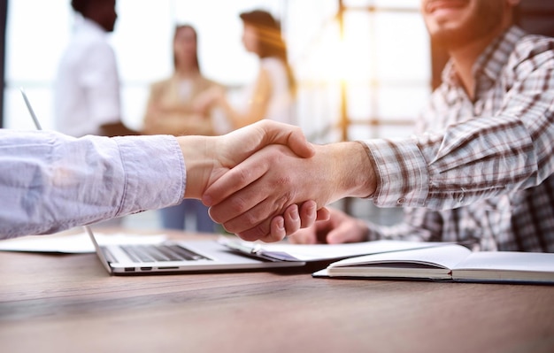 Businessman shaking hands businessman in the office success concept