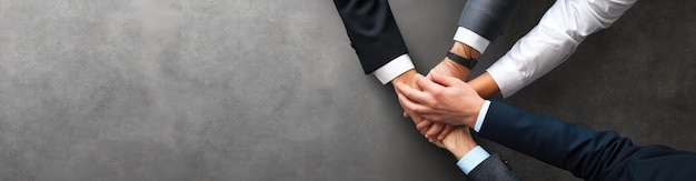 Photo businessman shaking hands in partnership agreement against grey background