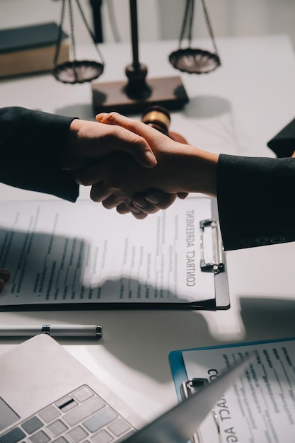 Businessman shaking hands to seal a deal with his partner lawyers or attorneys discussing a contract agreement