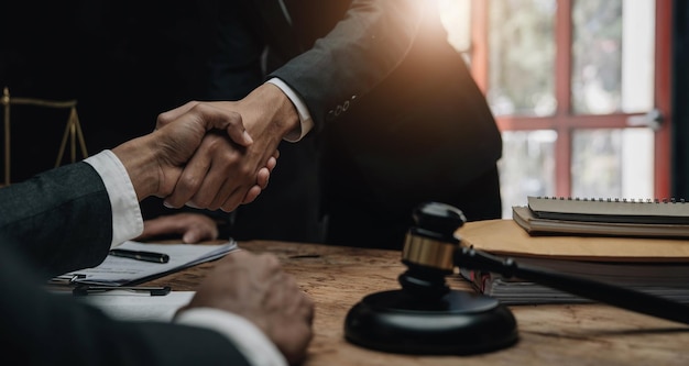 Businessman shaking hands to seal a deal with his partner lawyers or attorneys discussing a contract agreement