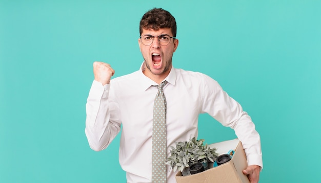 Businessman shouting aggressively with an angry expression or with fists clenched celebrating success. dismissal concept