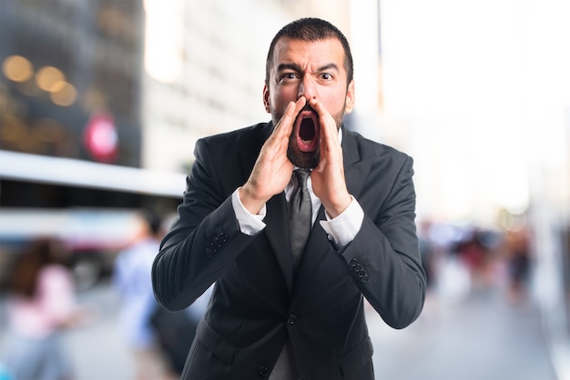 Businessman shouting on unfocused background