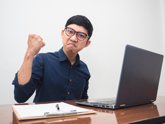 Businessman show fist up feels happy about successful with working on table