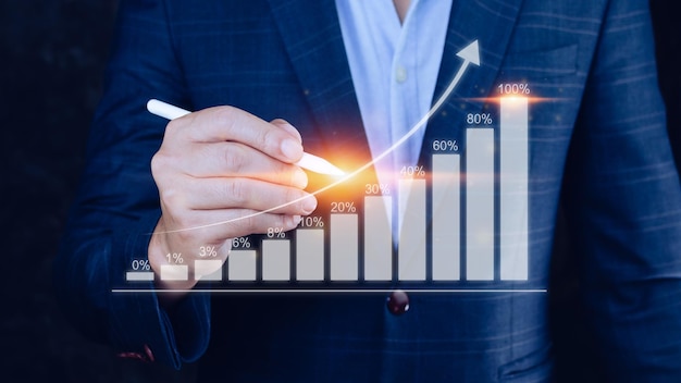 Businessman showing business growth on graph Hands touching graphs representing increasing profits financial symbols coming