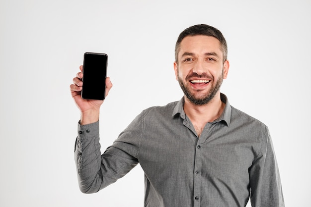 Businessman showing display of by mobile phone