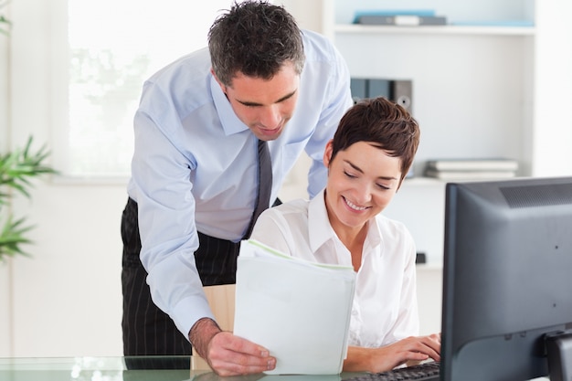 Businessman showing document to his colleague