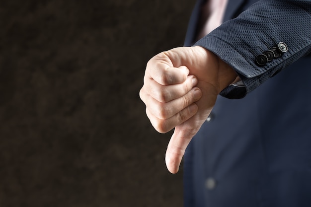 Businessman showing gesture with thumb down