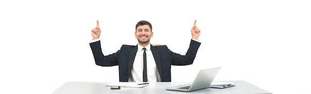 The businessman sitting at the desktop and gesturing on the white background