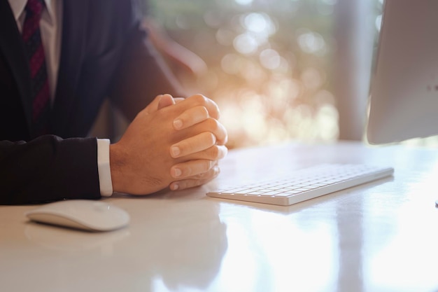 Businessman sitting to working at office desk have a coffee cup beside for efficient work  problems and concepts. businessman, working, business, technology, management, planning concepts.