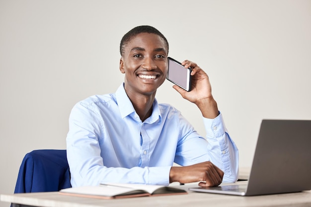 Businessman smile and phone for call at desk with laptop for reading communication email or report on the internet Black man happy and working in office with green screen phone in at table