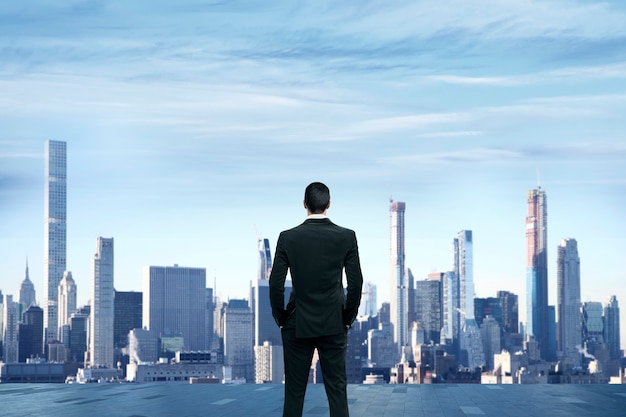 Businessman stand at rooftop of building