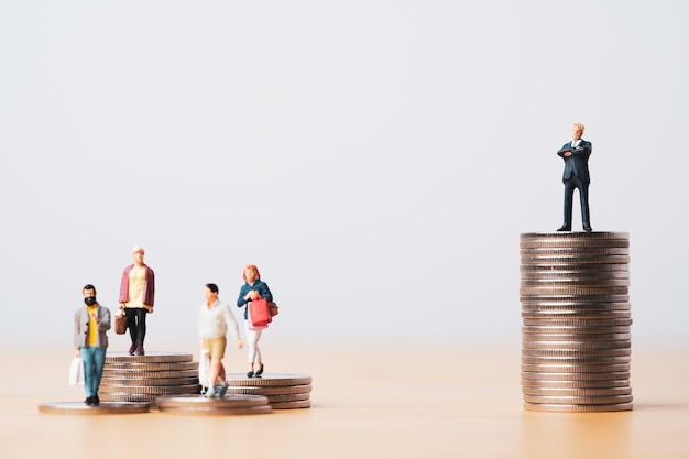 Businessman standing on higher coins stacking with shoppers people for investor concept.