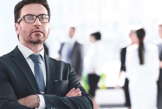 Businessman standing near the window and looking into it