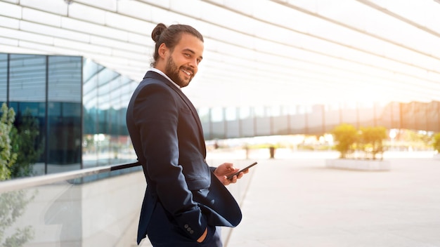 Businessman standing outdoor use smartphone