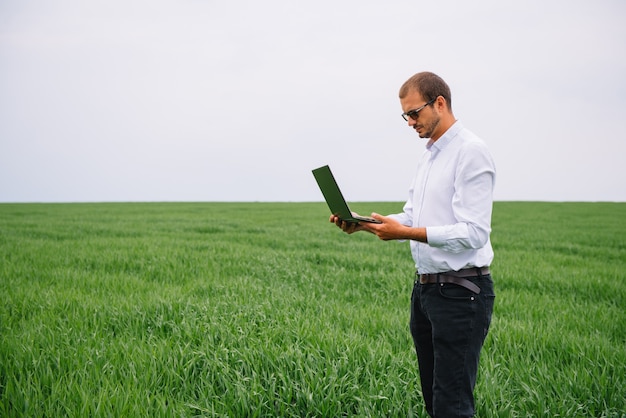 businessman standing in a wheat field