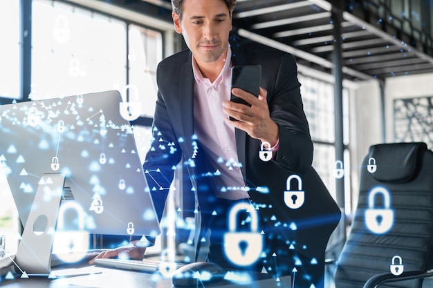 Businessman in suit checking cyber security using smart phone to protect clients confidential information IT hologram lock icons over modern panoramic office background