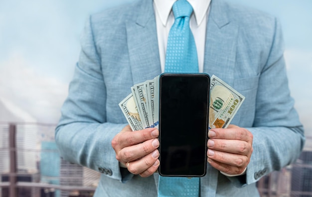 Businessman in suit hold dollar and tablet at office