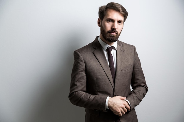 Businessman in suit light wall