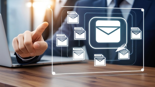 A businessman in a suit points at a digital screen with an email icon symbolizing online communication