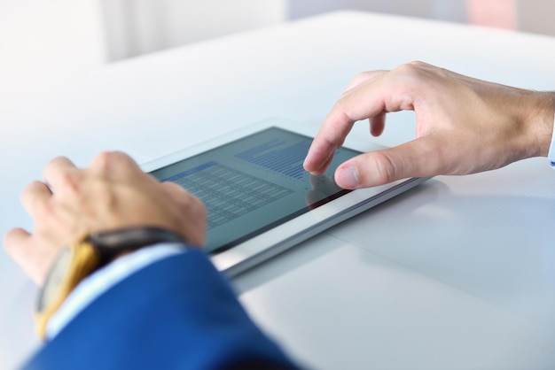 Businessman in suit using digital tablet