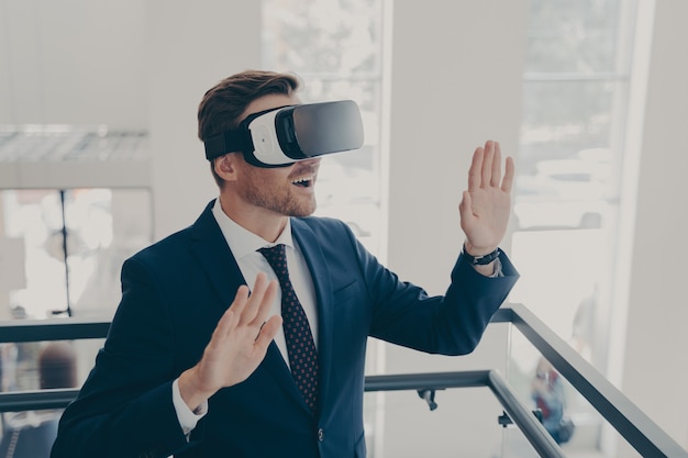 Businessman in suit using virtual reality glasses in office