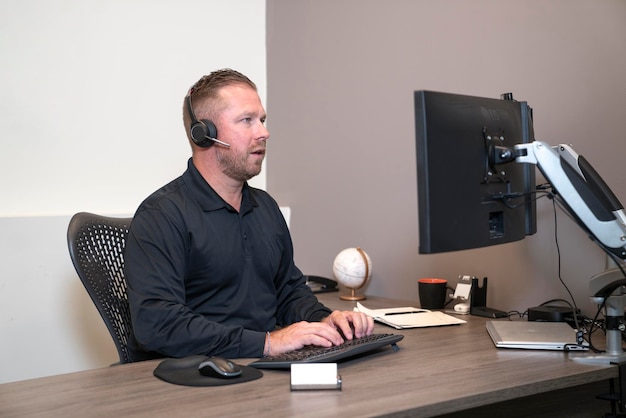 Businessman taking notes during online meeting