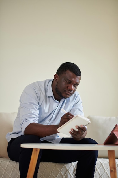 Businessman Taking Notes in Planner