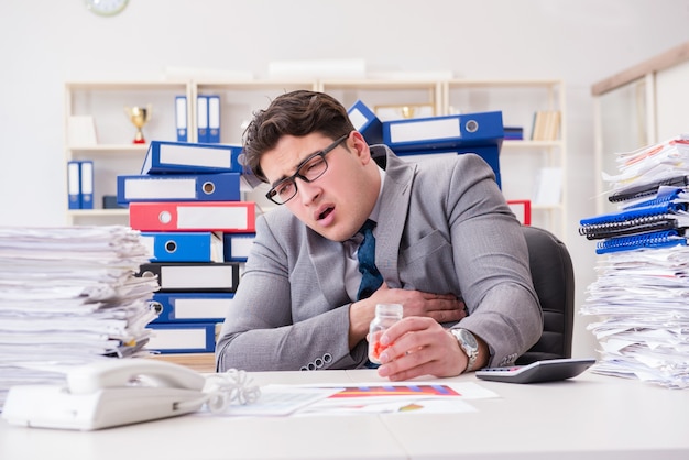 Businessman taking pills to cope with stress