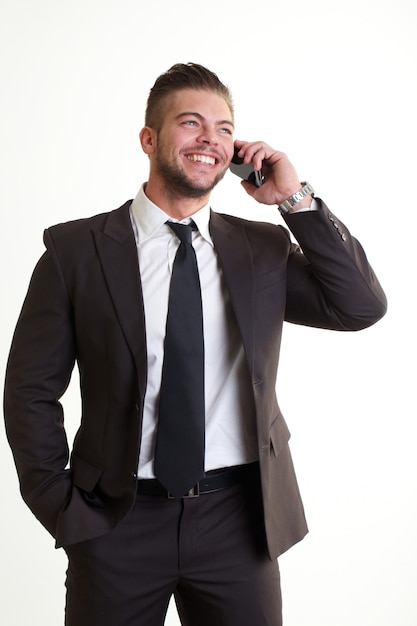 Businessman talking to mobile in office