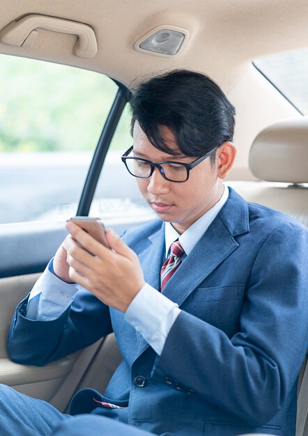 Businessman talking on the phone in car