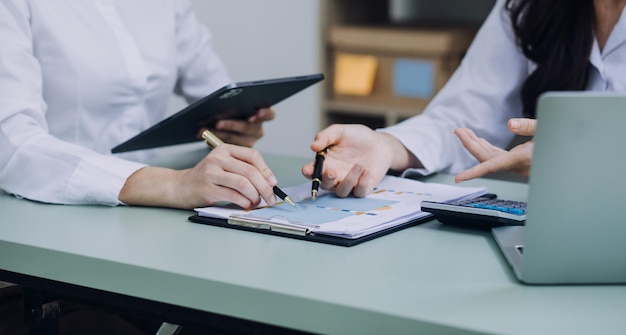 Businessman and team analyzing financial statement Finance task with smart phone and laptop and tablet Wealth management concept