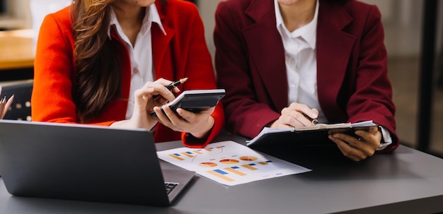 Businessman and team analyzing financial statement Finance task with smart phone and laptop and tablet Wealth management concept