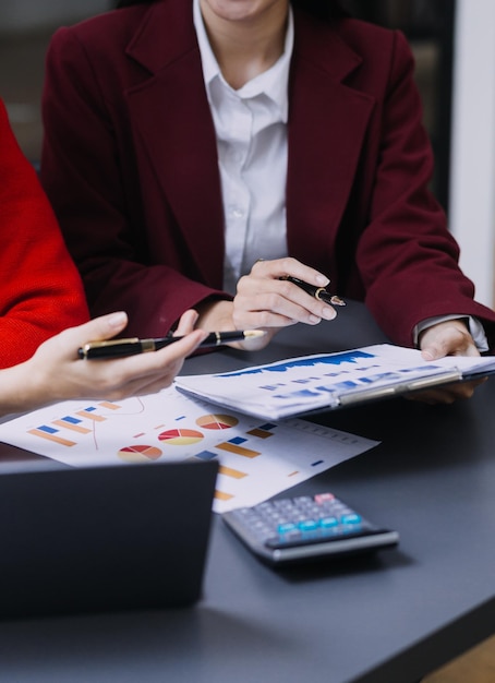 Businessman and team analyzing financial statement Finance task with smart phone and laptop and tablet Wealth management concept