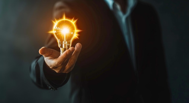 Businessman touching a glowing light bulb icon representing innovation and new ideas