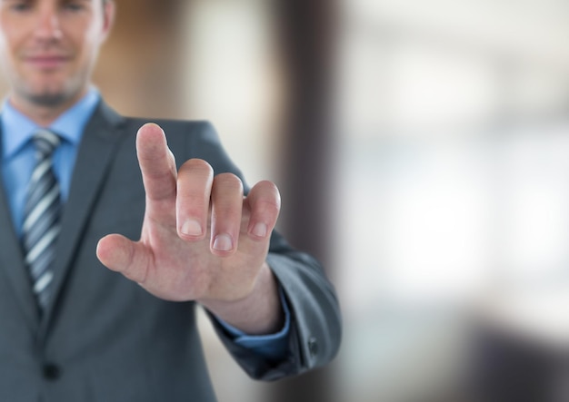 Businessman touching screen in office