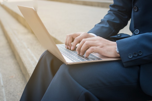 Businessman use computer outdoor